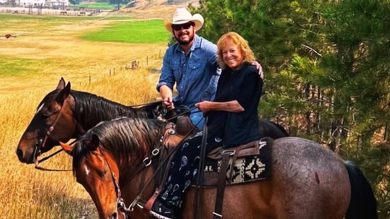 (l-r): Cole Hauser and Cass Sperling Warner smiling while riding horses