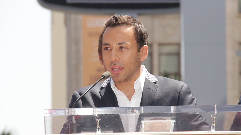 Howie D in formals speaking from a podium