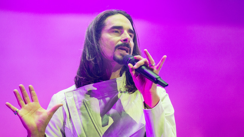 Kevin Richardson in long hair against pink background