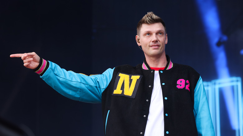 Nick Carter in a blue and black varsity jacket
