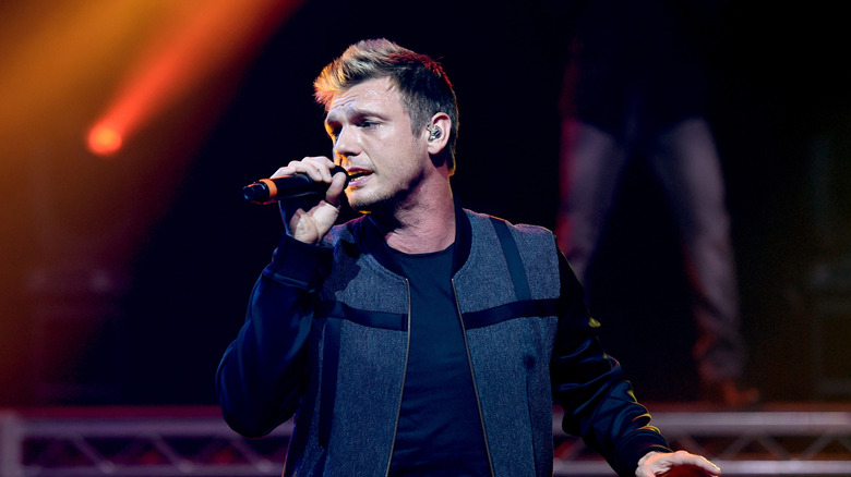 Nick Carter singing in a black textured jacket