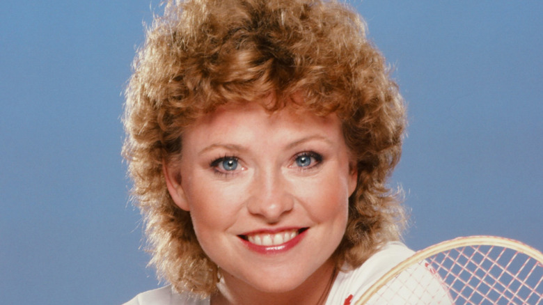 Lauren Tewes smiling while holding racket