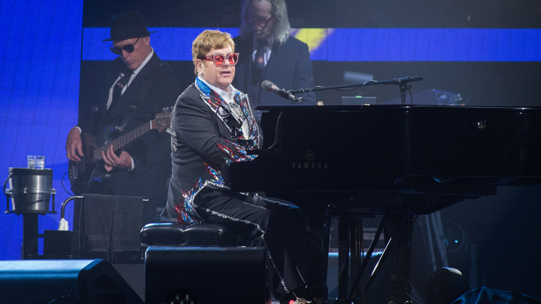 Elton John plays the piano