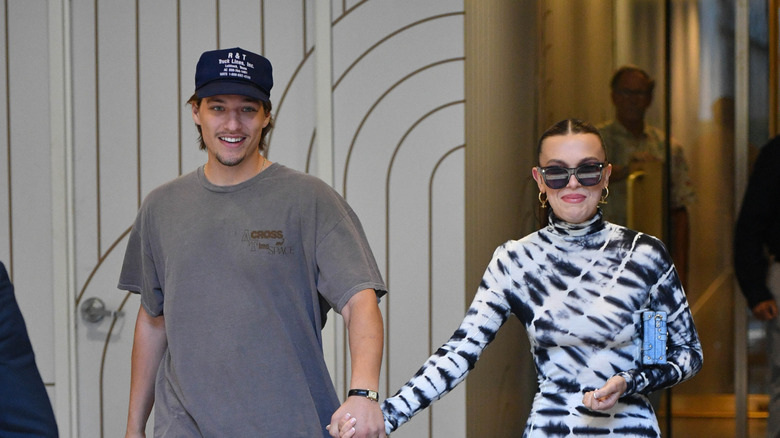 Jake Bongiovi and Millie Bobby Brown walking