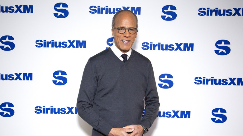 Lester Holt stands in front of a SiriusXM background