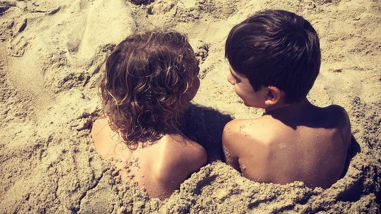 Back view of Neve Campbell's two boys, Caspian and Raynor, at the beach