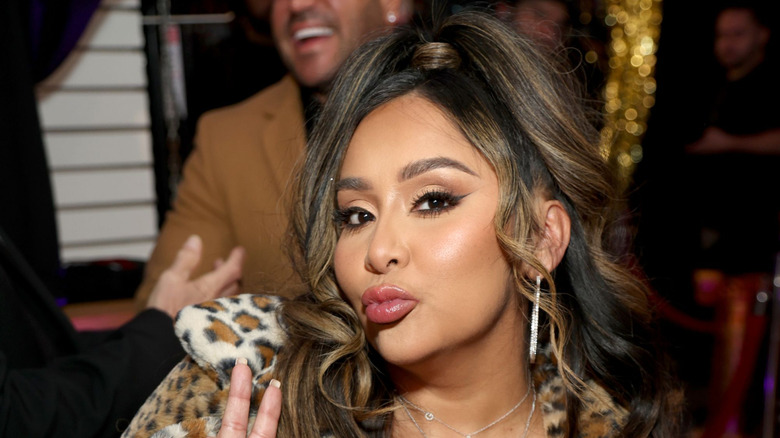 Snooki holding onto the rope of a wrestling ring