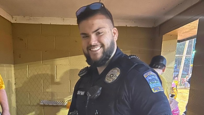 Garry Chapman smiling for a photo in police uniform