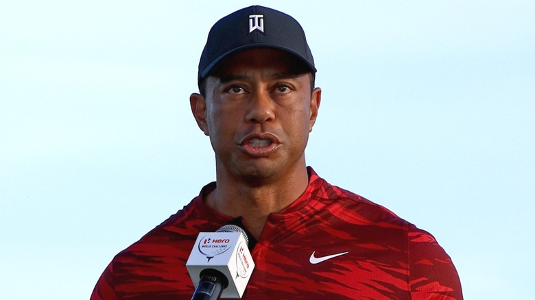 Tiger Woods speaking after winning a trophy in 2021