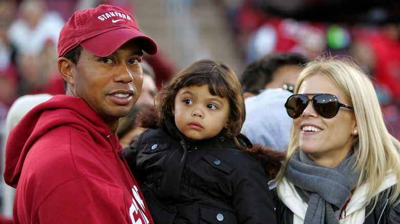 Tiger Woods holding his daughter Sam next to his wife Elin Nordegren