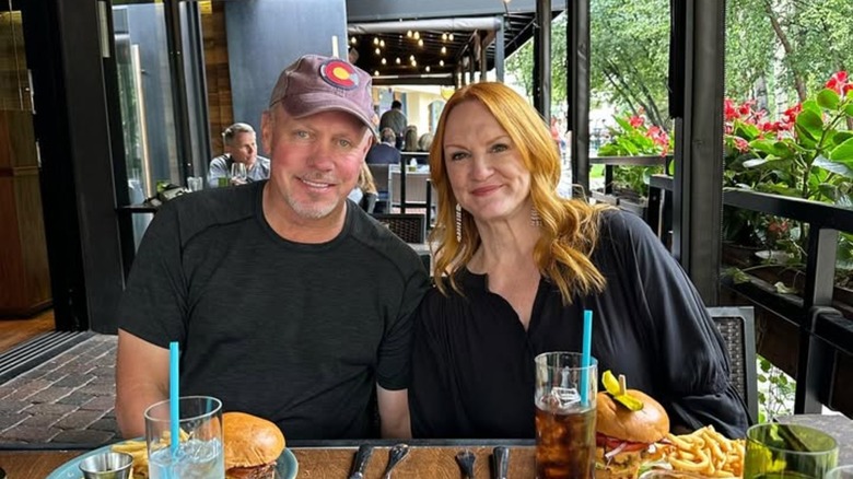 Ladd Drummond and Ree Drummond smiling at a dinner table