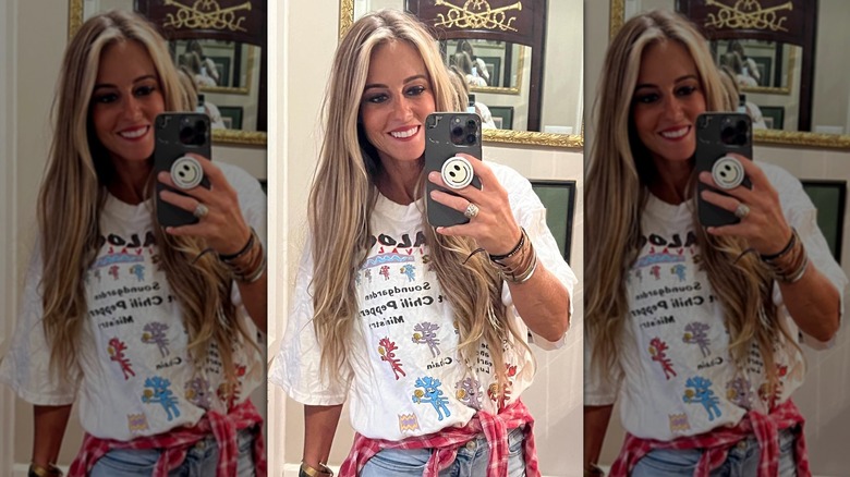 Nicole Curtis smiling while taking mirror selfie