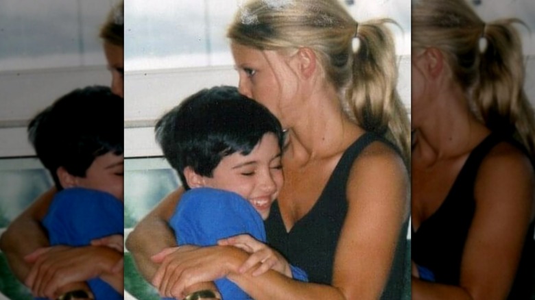 Nicole Curtis hugging her first son and kissing him on the head as he smiles