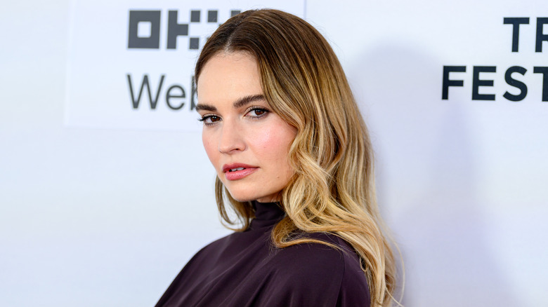 Closeup of Lily James posing on step-and-repeat