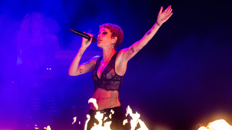 Halsey singing at a concert