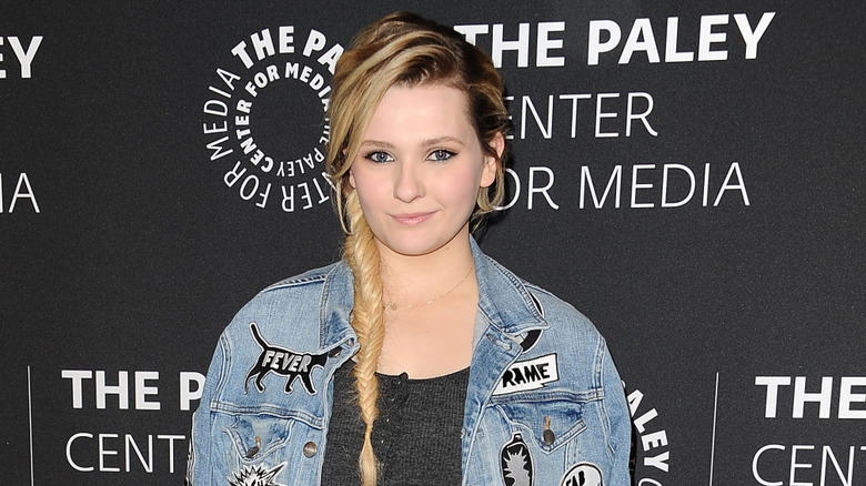 Abigail Breslin posing on step-and-repeat