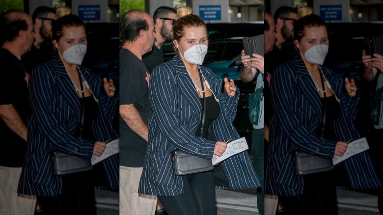 Abigail Breslin leaving car wearing face mask surrounded by crowds taking pictures
