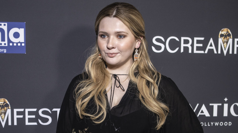 Closeup of Abigail Breslin posing on step-and-repeat