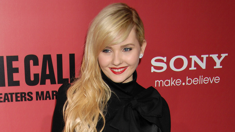 Abigail Breslin smiling on step-and-repeat