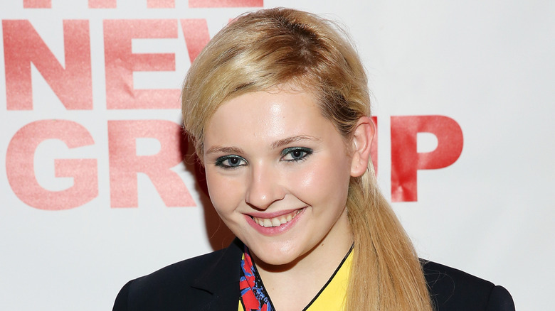 Closeup of Abigail Breslin smiling on step-and-repeat