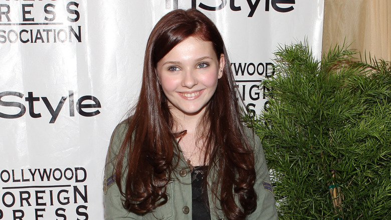 Young Abigail Breslin smiling on InStyle step-and-repeat