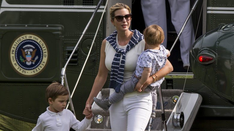 Ivanka Trump leaving helicopter with her children