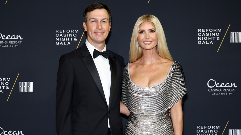 Ivanka Trump and Jared Kushner posing for photographs at an event