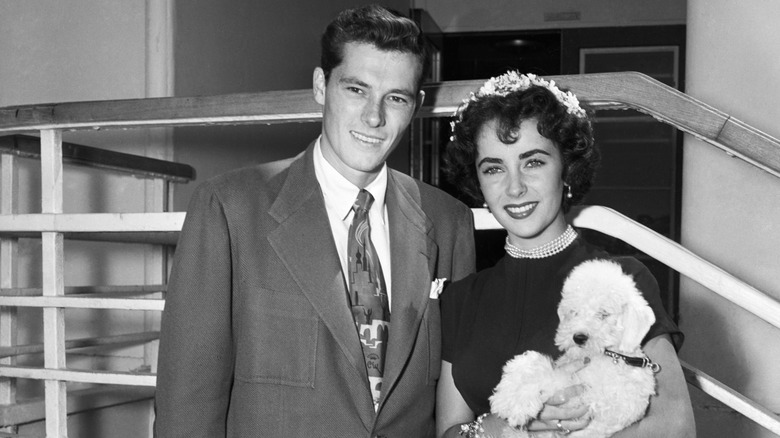 Elizabeth Taylor with Conrad Hilton Jr. and their pet dog