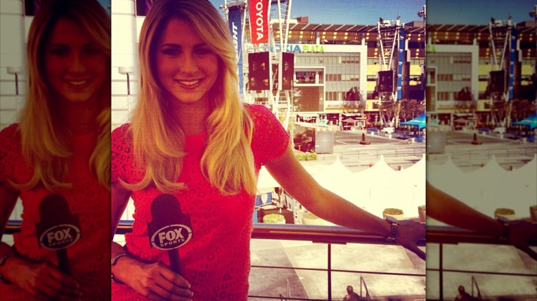 Laura Rutledge posing on balcony holding Fox Sports mic