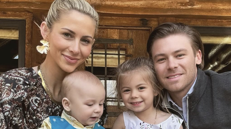 Laura and Josh Rutledge posing with their son and daughter on their laps