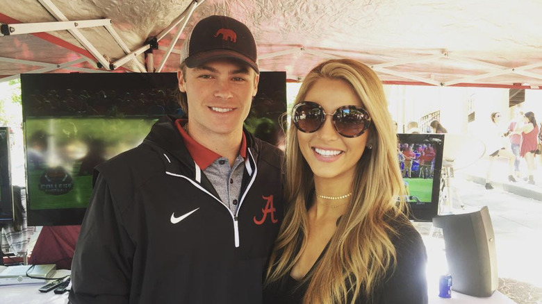 Josh and Laura Rutledge smiling at University of Alabama tailgate