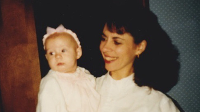 Laura Rutledge's mother holding her as a baby and smiling