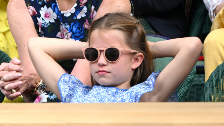 Princess Charlotte sitting back wearing sunglasses