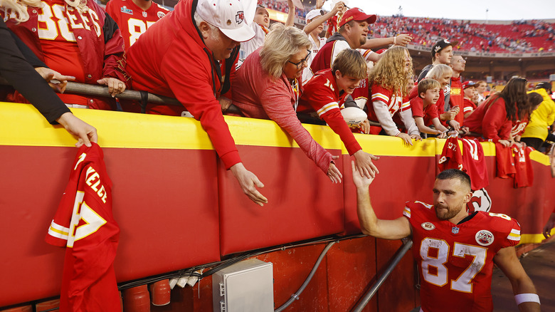Travis Kelce high-fiving fans
