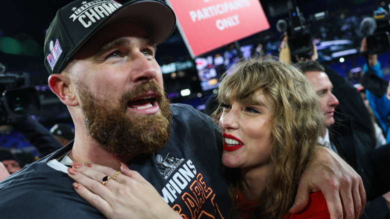 Taylor Swift and Travis Kelce smiling 