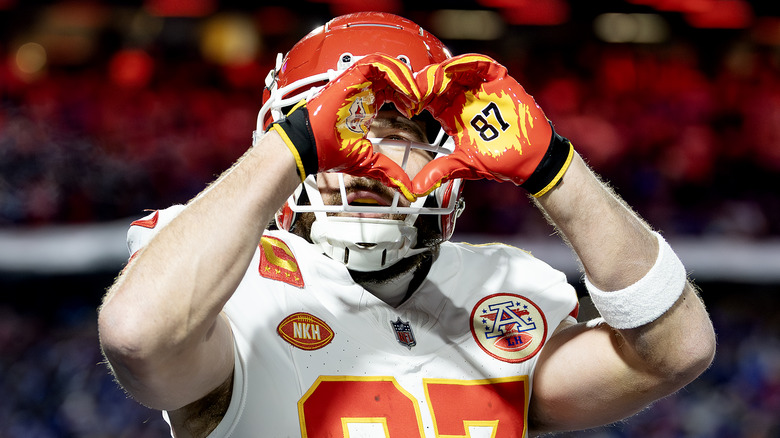 Travis Kelce making a heart symbol with his hands during the Buffalo Bills game