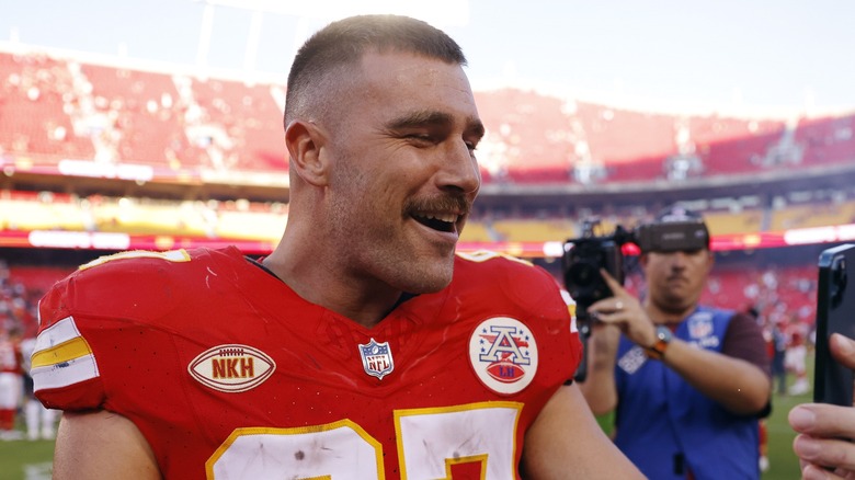 Travis Kelce smiling on the field