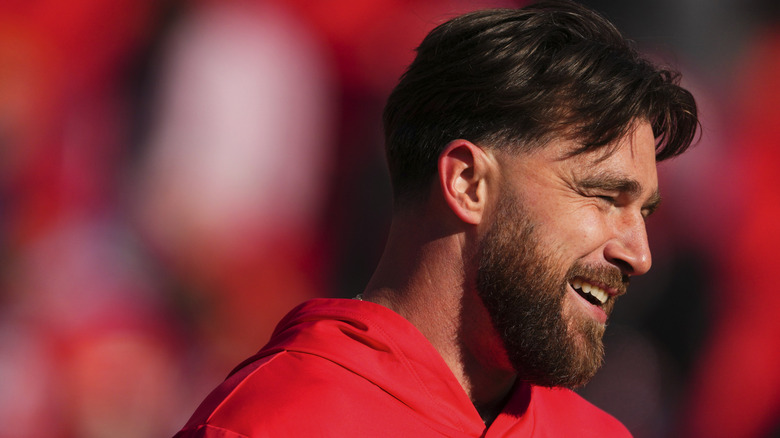 Travis Kelce smiling on the field