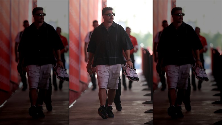 Travis Kelce in dark lighting wearing oversized fit.