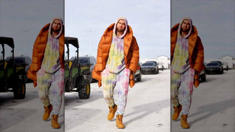 Travis Kelce walking in a pajama set.