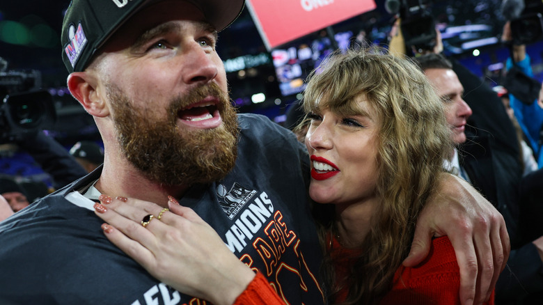 Travis Kelce and Taylor Swift embracing