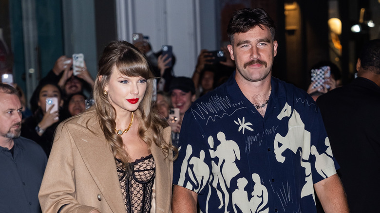 Taylor Swift and Travis Kelce holding hands