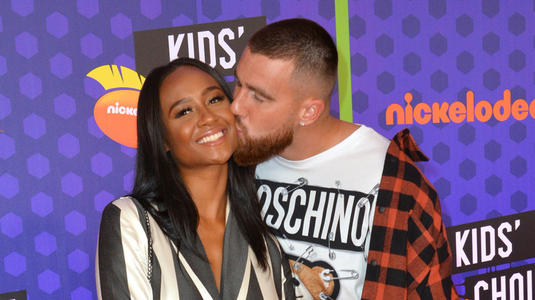 Travis Kelce kissing Kayla Nicole at a red carpet event