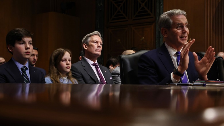 Cole Bessent Freeman, Caroline Bessent Freeman, John Freeman, and Scott Bessent attend testimony before the Senate Finance Committee in Washington, DC (2025)