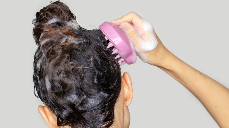 Woman massaging her scalp 