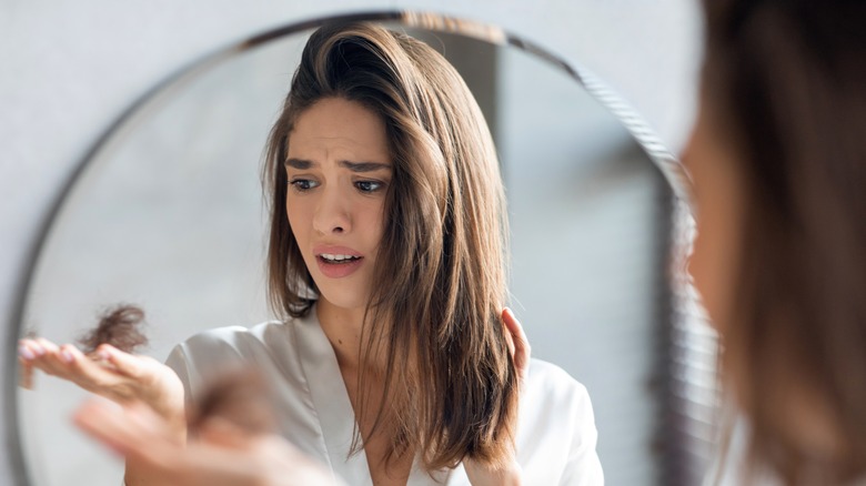 Woman panicking over hair loss