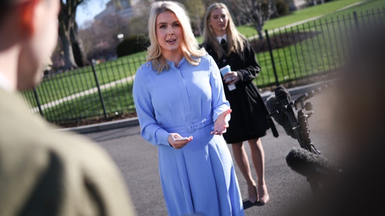 Karoline Leavitt speaks in an oversized blue dress outside the West Wing of the White House (2025)