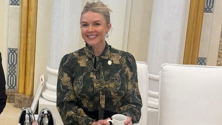 Karoline Leavitt smiles in a green and gold blouse (2025)