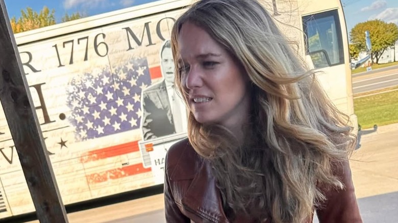 Tricia McLaughlin walking in a brown leather jacket