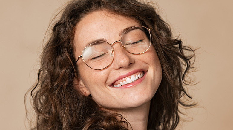 Woman with freckles smiling at the camera